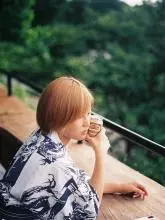 Woman on balcony, Trees , Colour