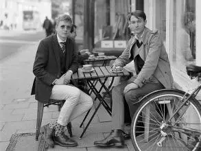 Two Men, sat on chairs and table, grey